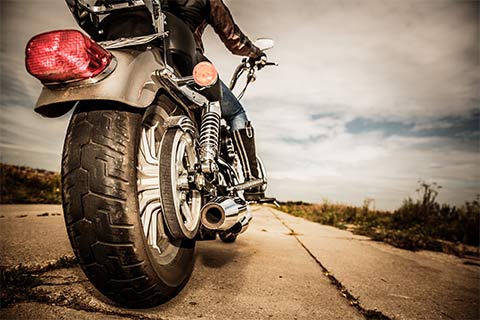 motorcycle insurance with a man riding a black motorcycle in treynor