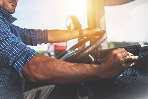 Person driving a tractor with Auto Insurance in Council Bluffs, IA