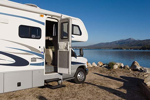 RV parked infront of a lake with Auto Insurance in Papillion, NE.