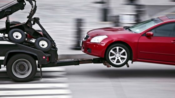 Tow Truck Pulling Car with car Insurance in Bellevue, Council Bluffs, Omaha, Papillion, Treynor