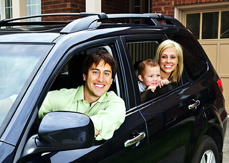family sitting in car with home and auto insurance bundle